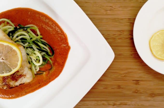 Broiled Cod with Roasted Red Pepper Coulis on white plate