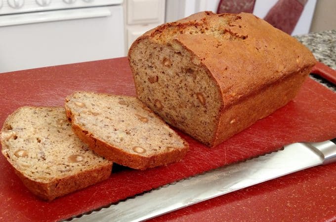 banana bread with knife on cutting board