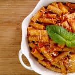 rigatoni and tomato sauce in white bowl