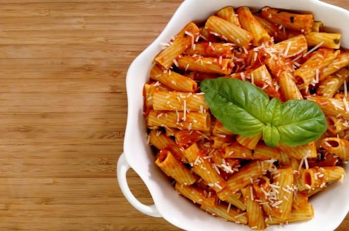 rigatoni and tomato sauce in white bowl
