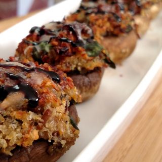 Bacon Stuffed Mushrooms in row on plate