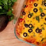 chicken enchiladas in a baking dish. Cilantro and Avocado.