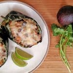 Stuffed Poblano Peppers on a plate. cilantro, avocado, lime.