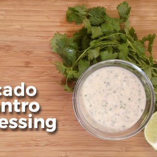 Avocado Cilantro Dressing on a bowl with lime