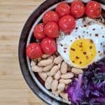 Farro Grain Bowl with Purple Kale, Cherry Tomatoes, Cannellini Bean and a Fried Egg