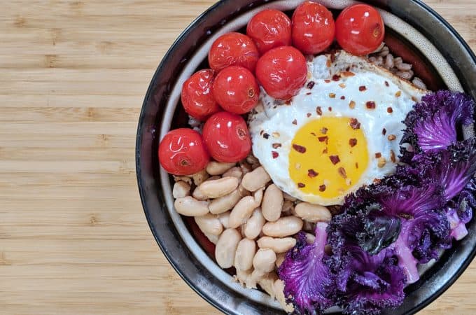 Farro Grain Bowl with Purple Kale, Cherry Tomatoes, Cannellini Bean and a Fried Egg
