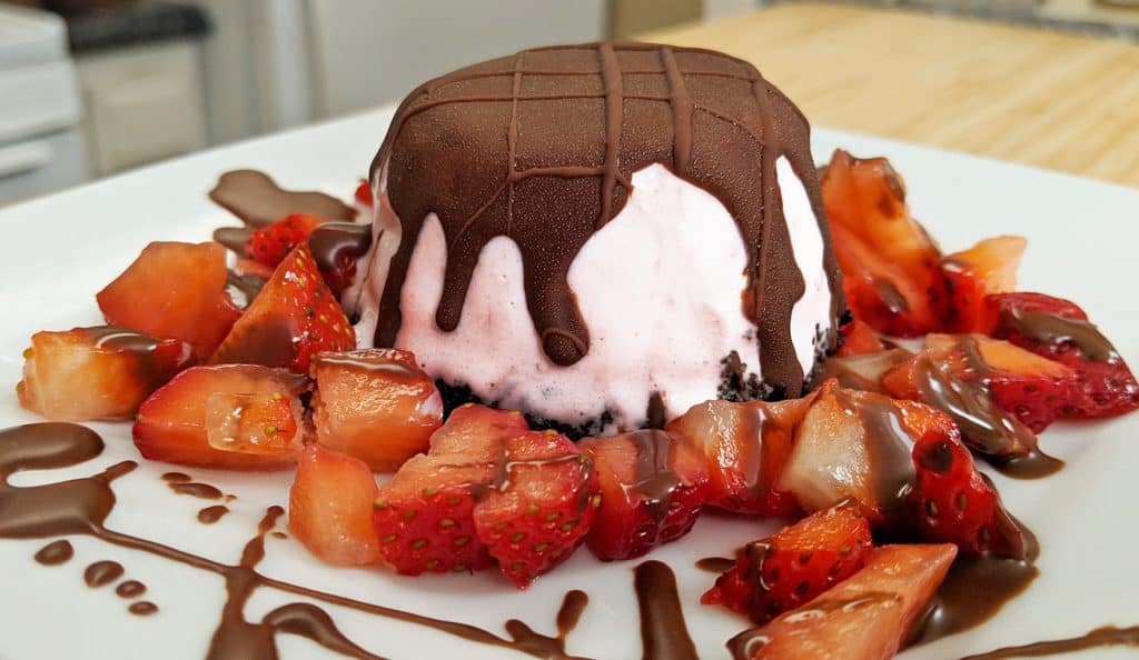 Mini Oreo Cookie Ice Cream Pie with Chocolate Shell Topping and Strawberries on a Plate
