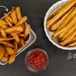 Baked French Fries on a white plate and Fried french fries in a fry basket with ketchup on a black background