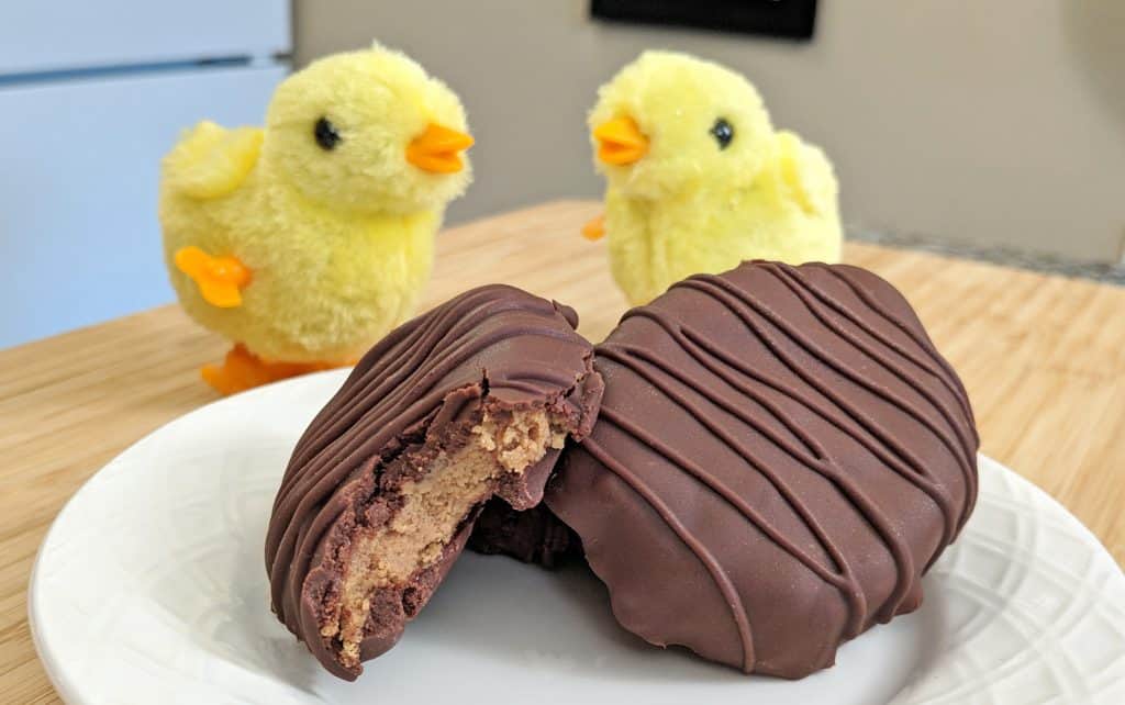 Keto Reese's Peanut Butter Cups on a white plate in egg shape with chicks