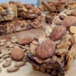Tiny Kitchen Zip Bars (Keto Granola Bars) with Almonds, Coconut, Sunflower Seeds, Pecans stacked on a wooden board