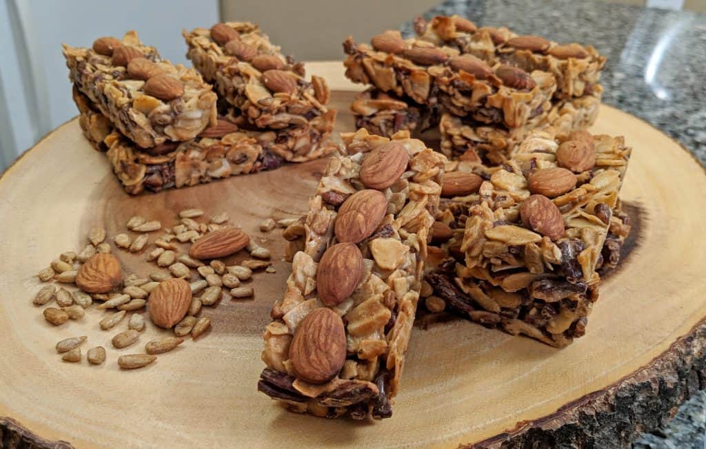 Tiny Kitchen Zip Bars (Keto Granola Bars) with Almonds, Coconut, Sunflower Seeds, Pecans stacked on a wooden board