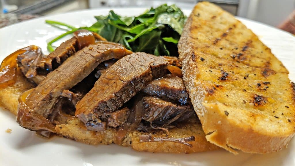 brisket sandwich with toasted bread and spinach