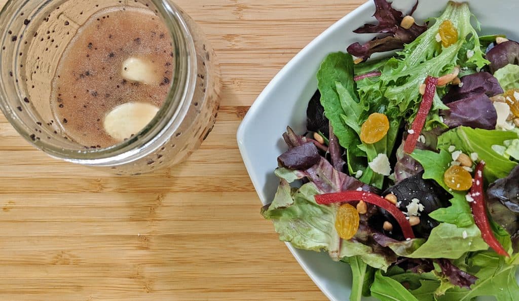 Salad with bottle of salad dressing