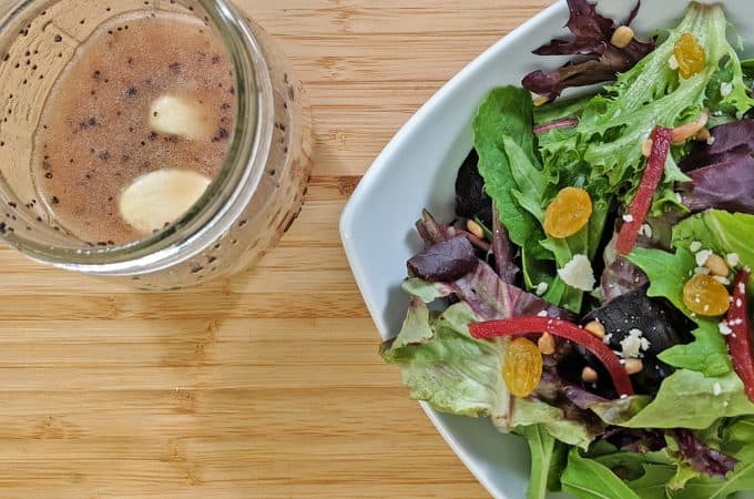 Salad with bottle of salad dressing
