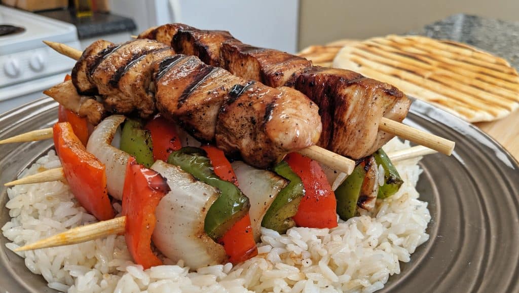 stacks of kabobs on rice